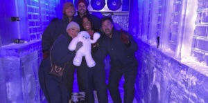 A photo of group of friends inside an igloo-themed escape room